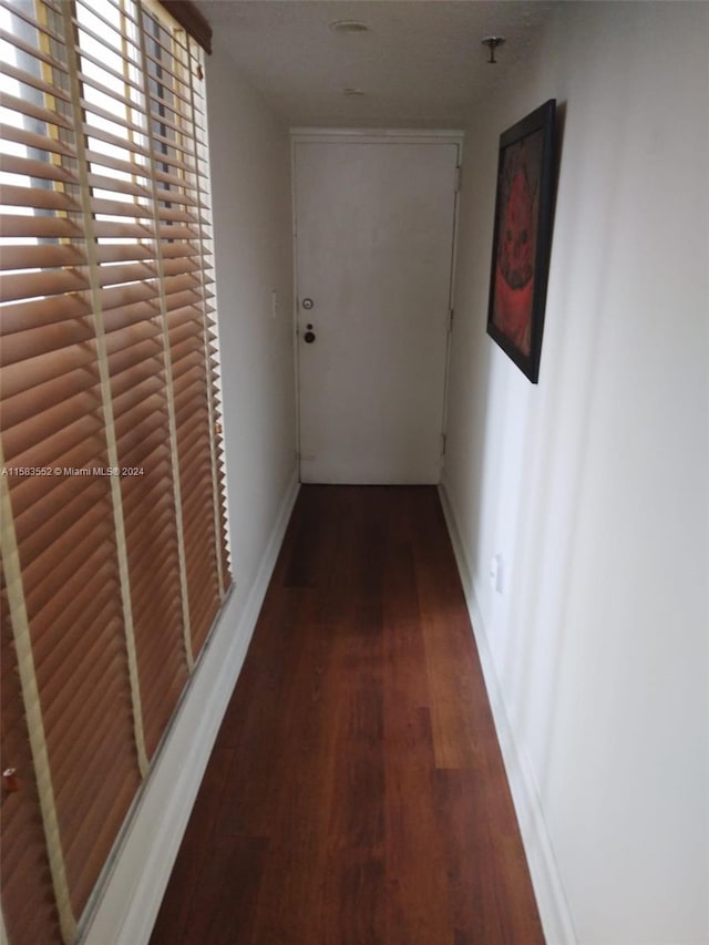 hall with dark hardwood / wood-style floors