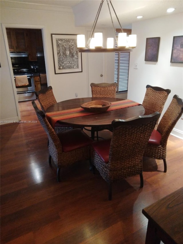 dining room with hardwood / wood-style floors and a notable chandelier