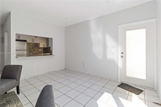 unfurnished living room with light tile patterned floors