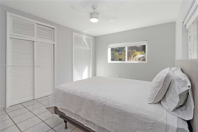 tiled bedroom with ceiling fan