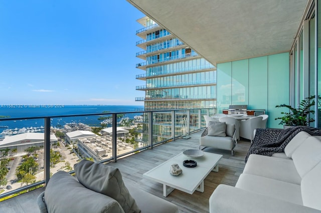 balcony with an outdoor hangout area, a water view, and grilling area