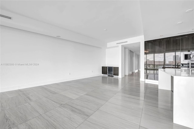 unfurnished living room featuring light tile flooring