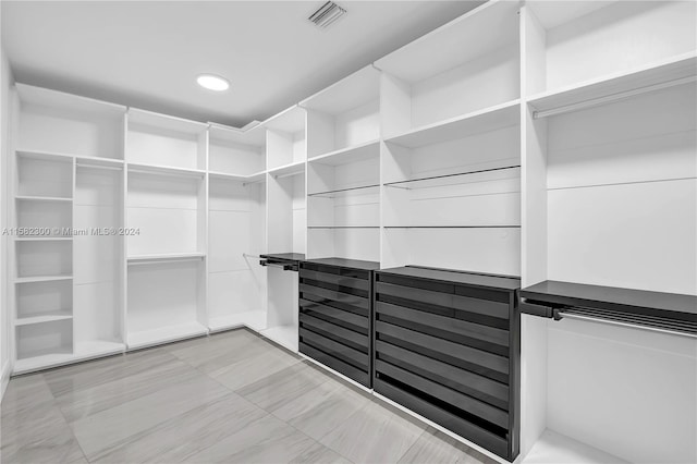 spacious closet with light tile flooring