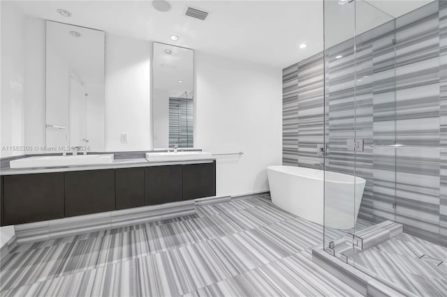 bathroom with dual sinks, tile floors, a tub, and large vanity