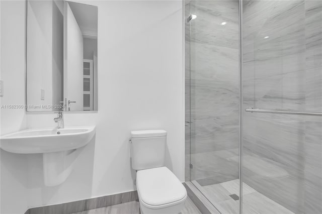 bathroom featuring an enclosed shower and toilet