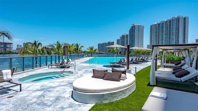 view of swimming pool with a patio area and a community hot tub