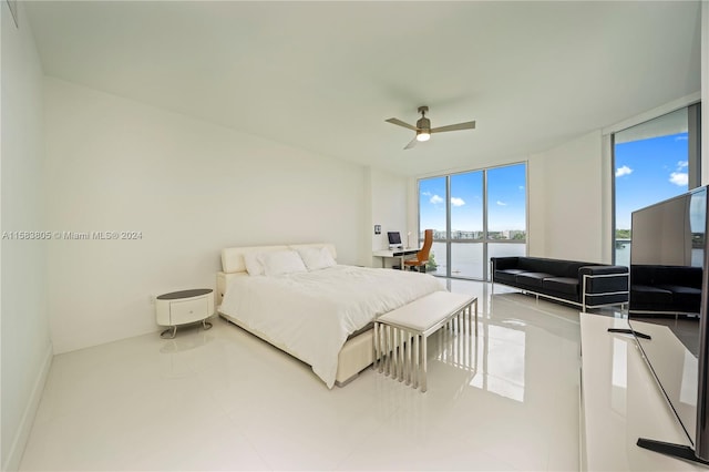 tiled bedroom featuring a wall of windows, a water view, and ceiling fan