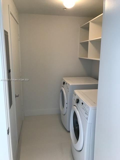 laundry room featuring tile flooring and washer and clothes dryer