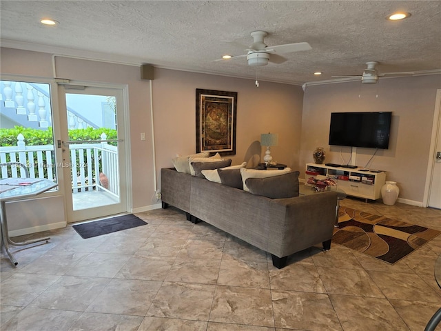 living room with ceiling fan, a textured ceiling, and ornamental molding