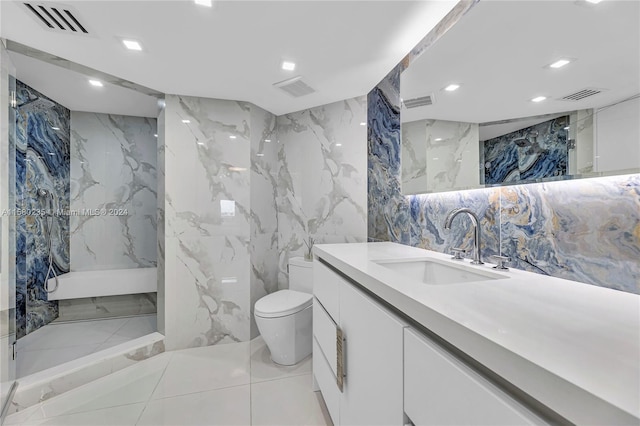 bathroom with tile walls, a tile shower, vanity with extensive cabinet space, toilet, and tile floors