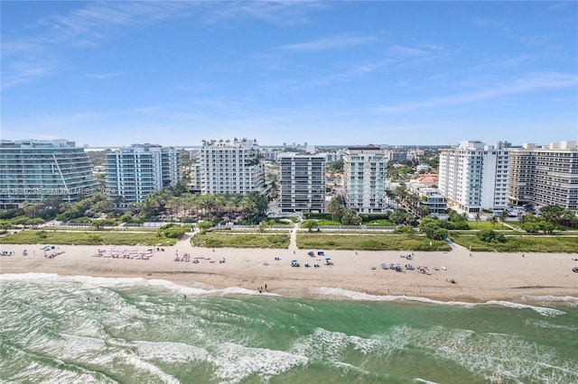 drone / aerial view featuring a view of the beach and a water view