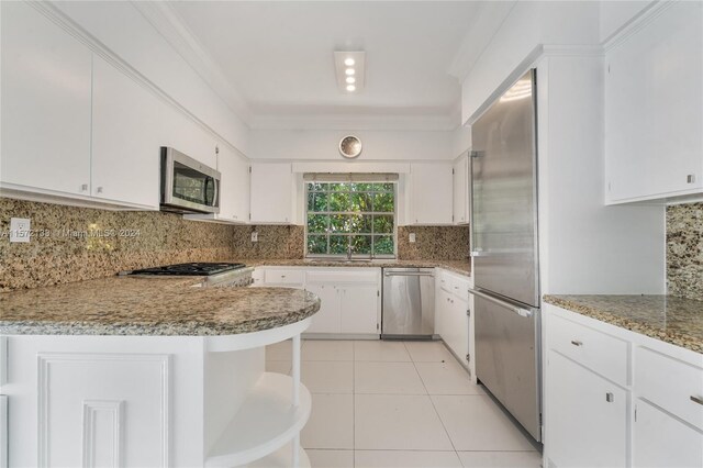 kitchen featuring backsplash, stainless steel appliances, white cabinetry, sink, and light tile floors