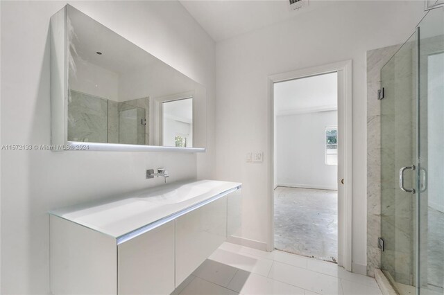 bathroom with an enclosed shower and tile floors