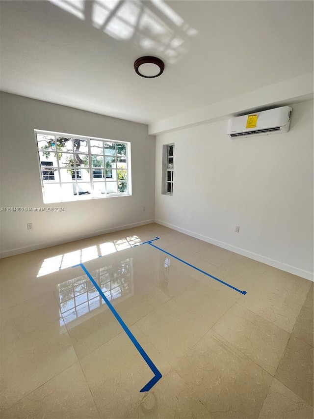 tiled empty room featuring an AC wall unit