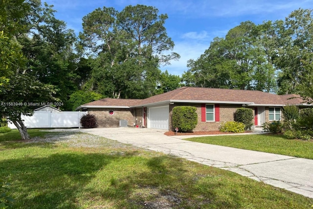 single story home featuring a front lawn and a garage