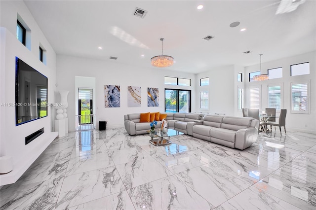 living room featuring a healthy amount of sunlight and light tile floors