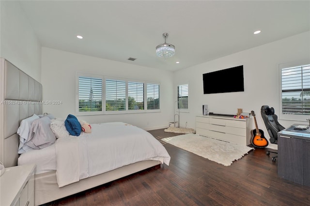 bedroom with dark hardwood / wood-style floors