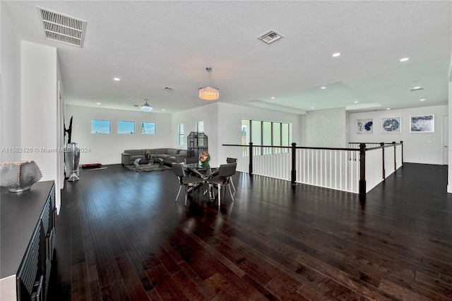 interior space featuring dark hardwood / wood-style flooring and a textured ceiling