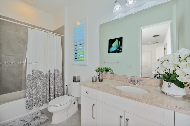 full bathroom with vanity with extensive cabinet space, toilet, tile floors, and shower / bath combo with shower curtain