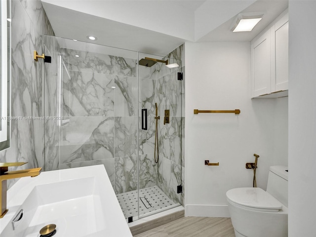 bathroom featuring sink, toilet, and a shower with shower door