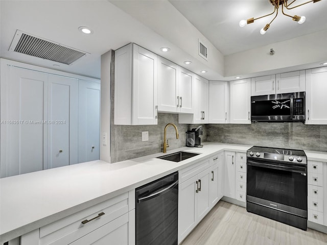 kitchen featuring white cabinets, sink, appliances with stainless steel finishes, and tasteful backsplash