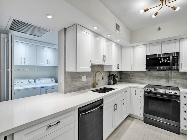 kitchen featuring appliances with stainless steel finishes, sink, tasteful backsplash, white cabinetry, and washing machine and dryer