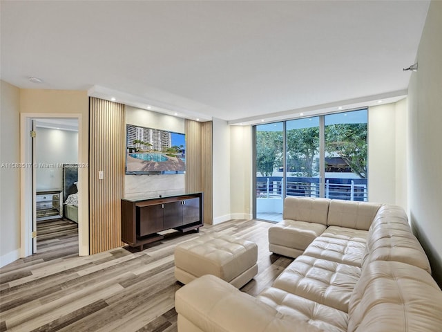 living room with floor to ceiling windows and light wood-type flooring