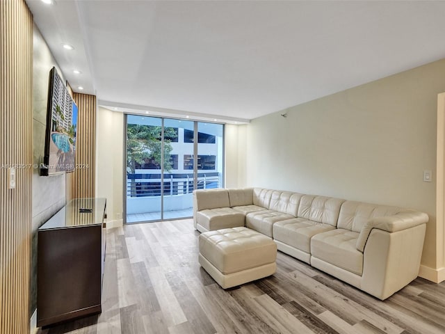 living room featuring floor to ceiling windows and light wood-type flooring