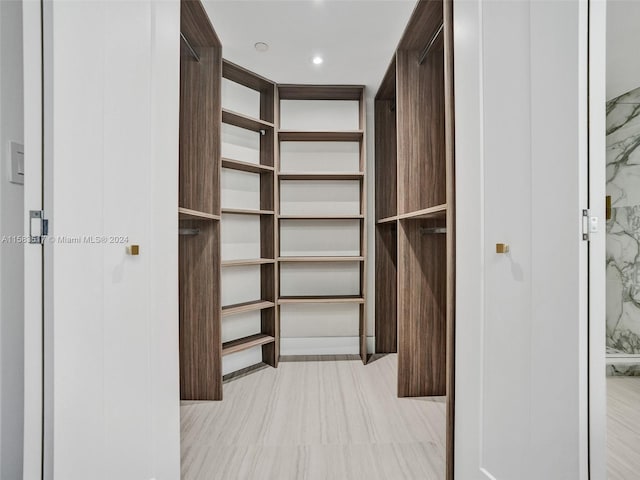 spacious closet with light tile floors