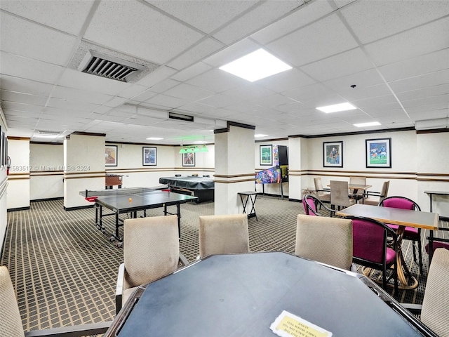 carpeted dining room featuring a drop ceiling