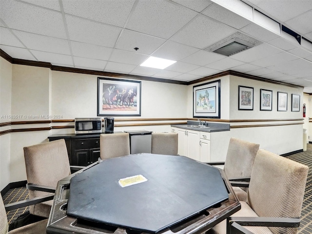 office space with crown molding and a paneled ceiling