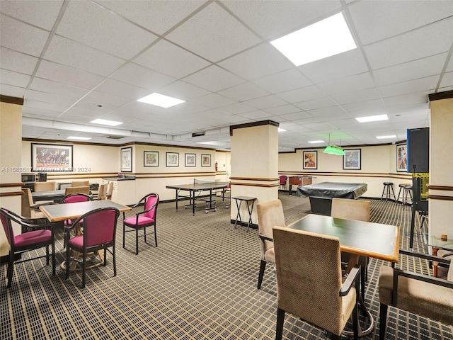 dining room with carpet flooring and a paneled ceiling