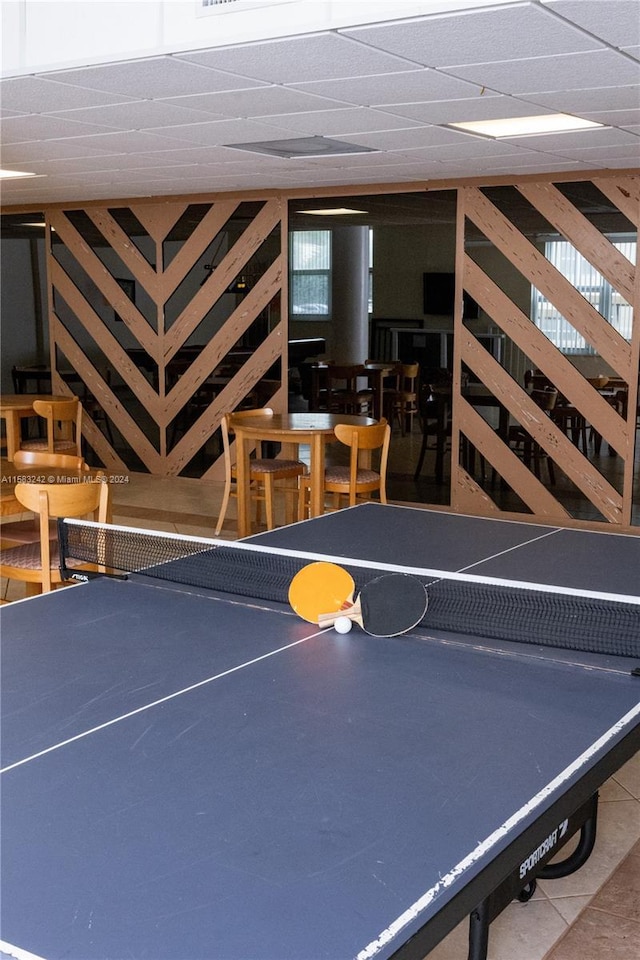 rec room featuring tile patterned flooring and a paneled ceiling