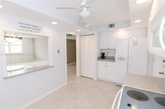 kitchen featuring light tile patterned floors, white refrigerator with ice dispenser, white cabinets, and ceiling fan