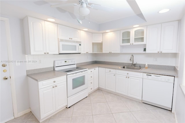 kitchen with white cabinetry, white appliances, sink, and light tile patterned floors