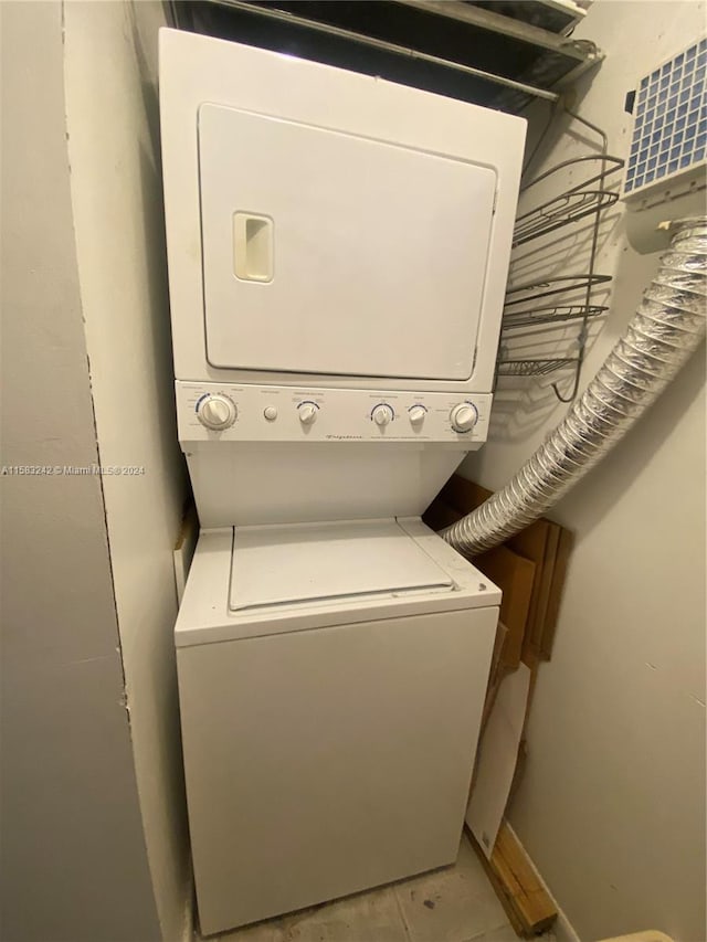 washroom featuring stacked washer and clothes dryer