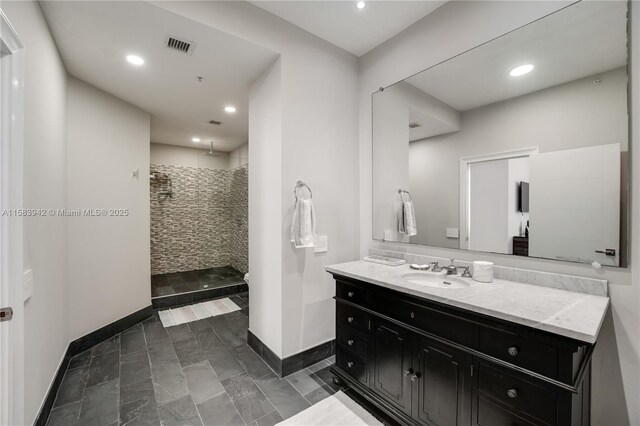 701 Brickell Key Blvd Unit Lph-06, Miami, FL 33131 - bathroom with tiled shower, vanity, baseboards, and recessed lighting
