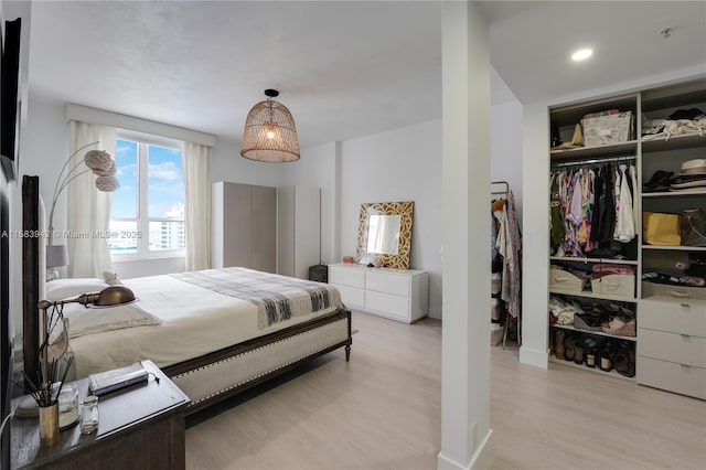 bedroom with a closet and light wood finished floors