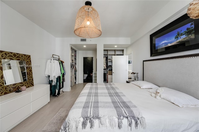 bedroom with visible vents and wood finished floors