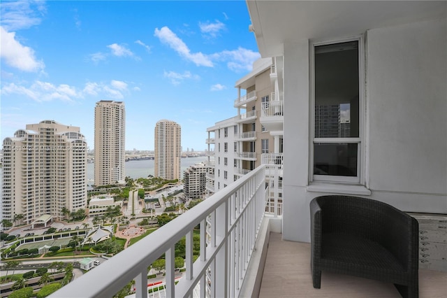 balcony featuring a view of city and a water view