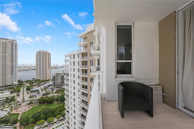 balcony featuring a view of city and a water view