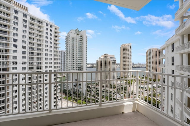 balcony featuring a view of city and a water view