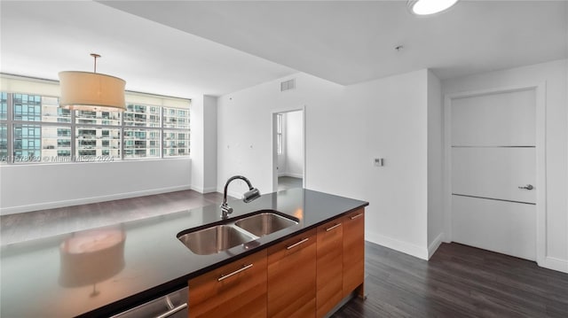 kitchen with pendant lighting, dark hardwood / wood-style floors, and sink