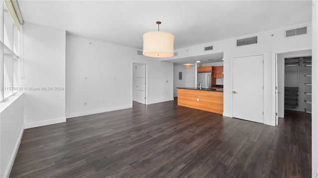 empty room featuring sink and dark wood-type flooring