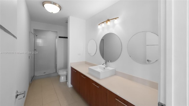 bathroom with large vanity, an enclosed shower, toilet, and tile flooring