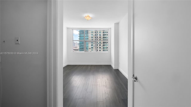 corridor with dark wood-type flooring