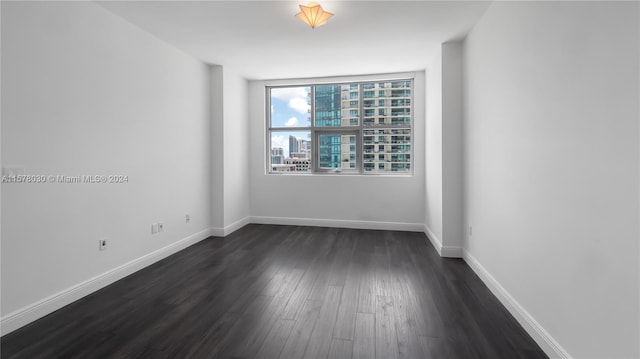 empty room featuring dark hardwood / wood-style floors