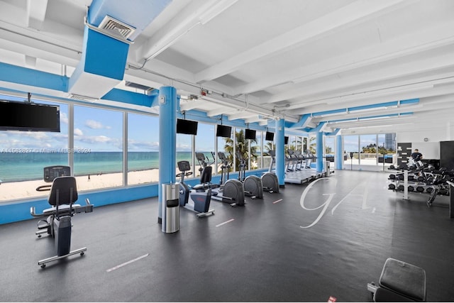 workout area featuring a water view