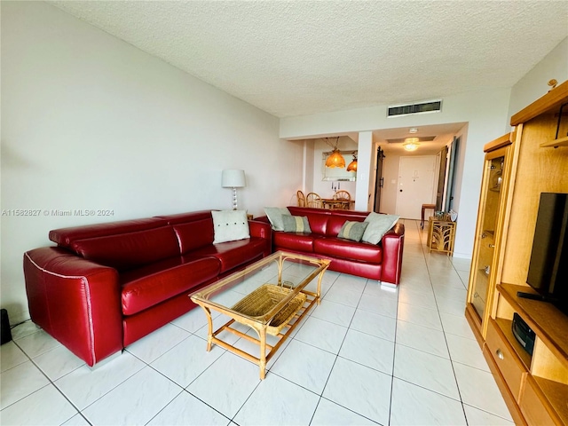 living room with tile flooring and a textured ceiling