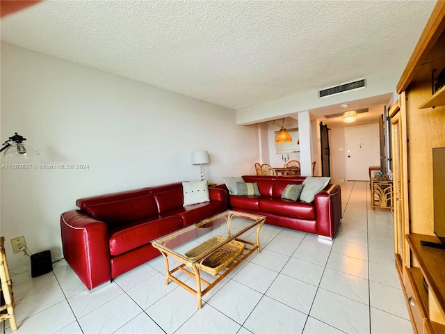 tiled living room featuring a textured ceiling